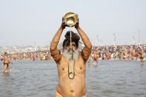 A Sadhu prays after taking in waters of river Ganges during second ritual bathing on occasion of Paush Purnima at ongoing "Kumbh Mela", or Pitcher Festival, in Allahabad